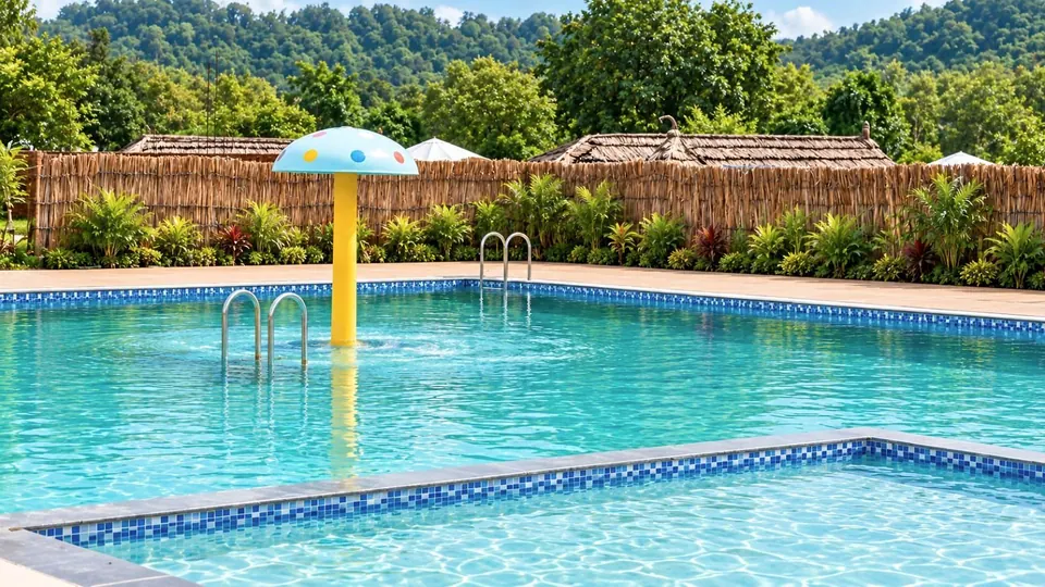 A swimming pool with a mosaic edge and a mushroom-shaped fountain in Bandhavgarh