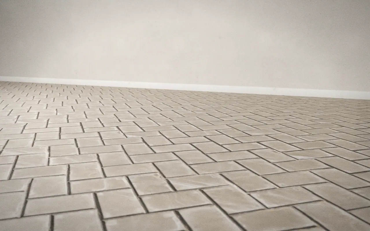 3D render of a herringbone-pattern tile floor in raking light